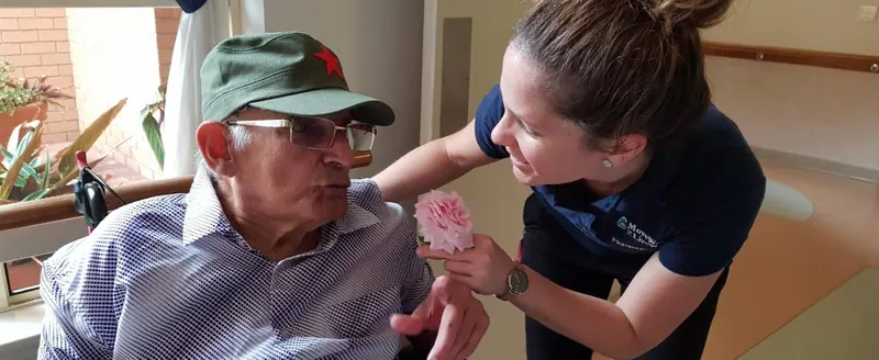 Danielle supporting an older client during a physiotherapy visit